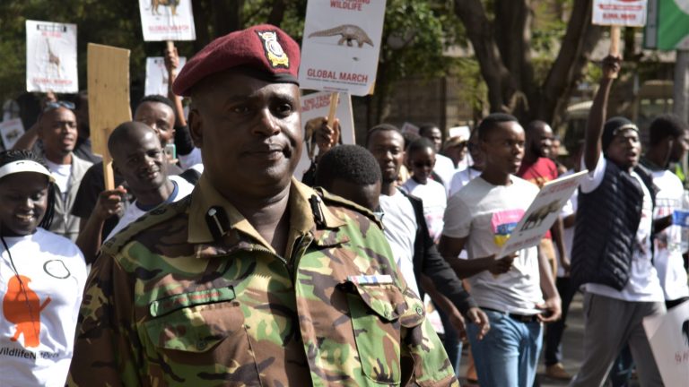 A Kenyan General Service Unit officer stands on duty among a crowd at a Nairobi rally