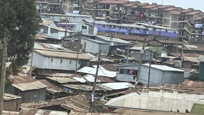 New apartment blocks rising above older Kibera housing.