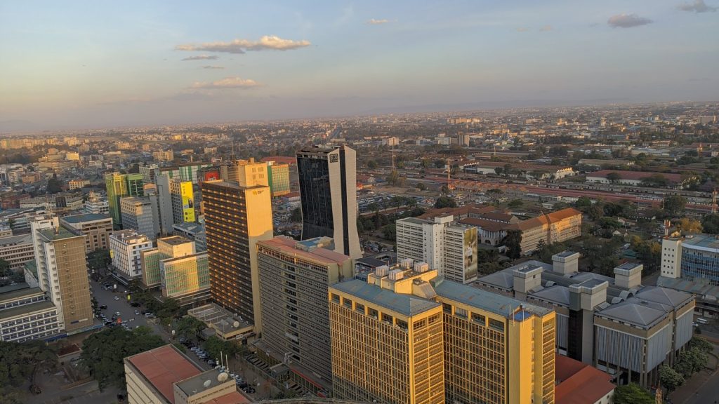 Office towers and low-rise blocks fill Nairobi's central business district, seen from above at golden hour