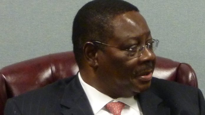 Malawian President Peter Mutharika seated in a formal chair wearing a dark suit