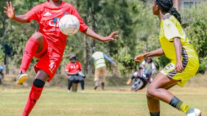A Kibera Soccer Women player controls the ball against Kenya Police Bullets