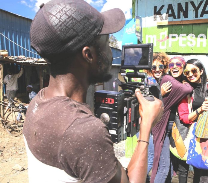 Hot Sun Foundation graduate filming in Kibera